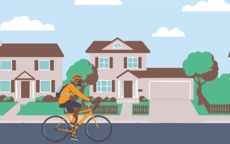 image of cyclist riding in neighborhood